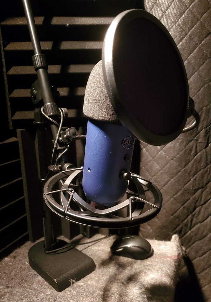 Blue Yeti microphone in a shock mount with a pop filter, inside Jimmy's Voice home studio.